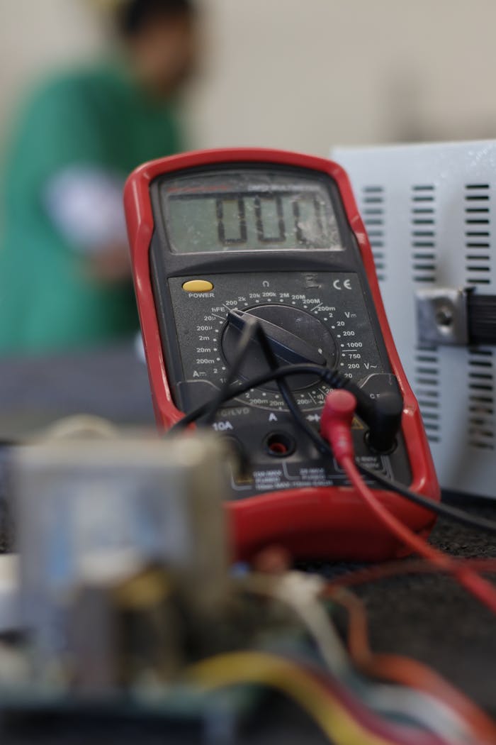 experience-img Close-up shot of a multimeter used for electrical measurements, with focus on the display.