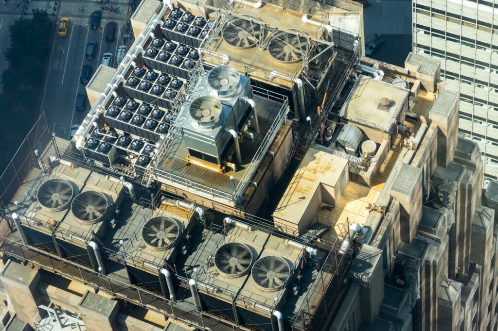 Overcoming Challenges Lessons Every Entrepreneur Must Learn High-angle shot of HVAC units on a city building's rooftop, showcasing industrial infrastructure.