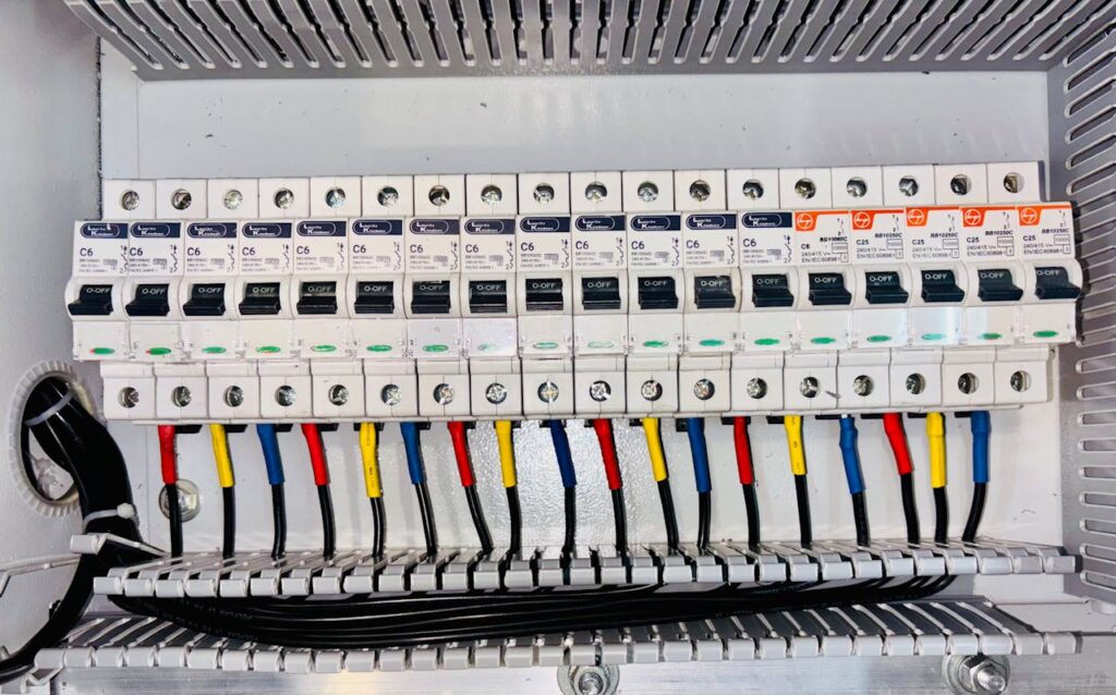 How Successful Entrepreneurs Maximize Productivity Close-up of an organized circuit breaker panel featuring color-coded electrical wiring.